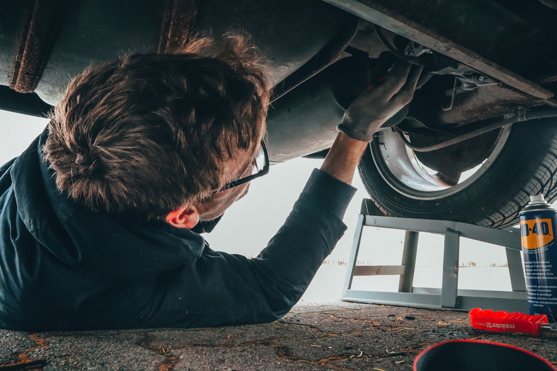 Technician inspecting a vehicle on ramps during a puncture repair in Waterford