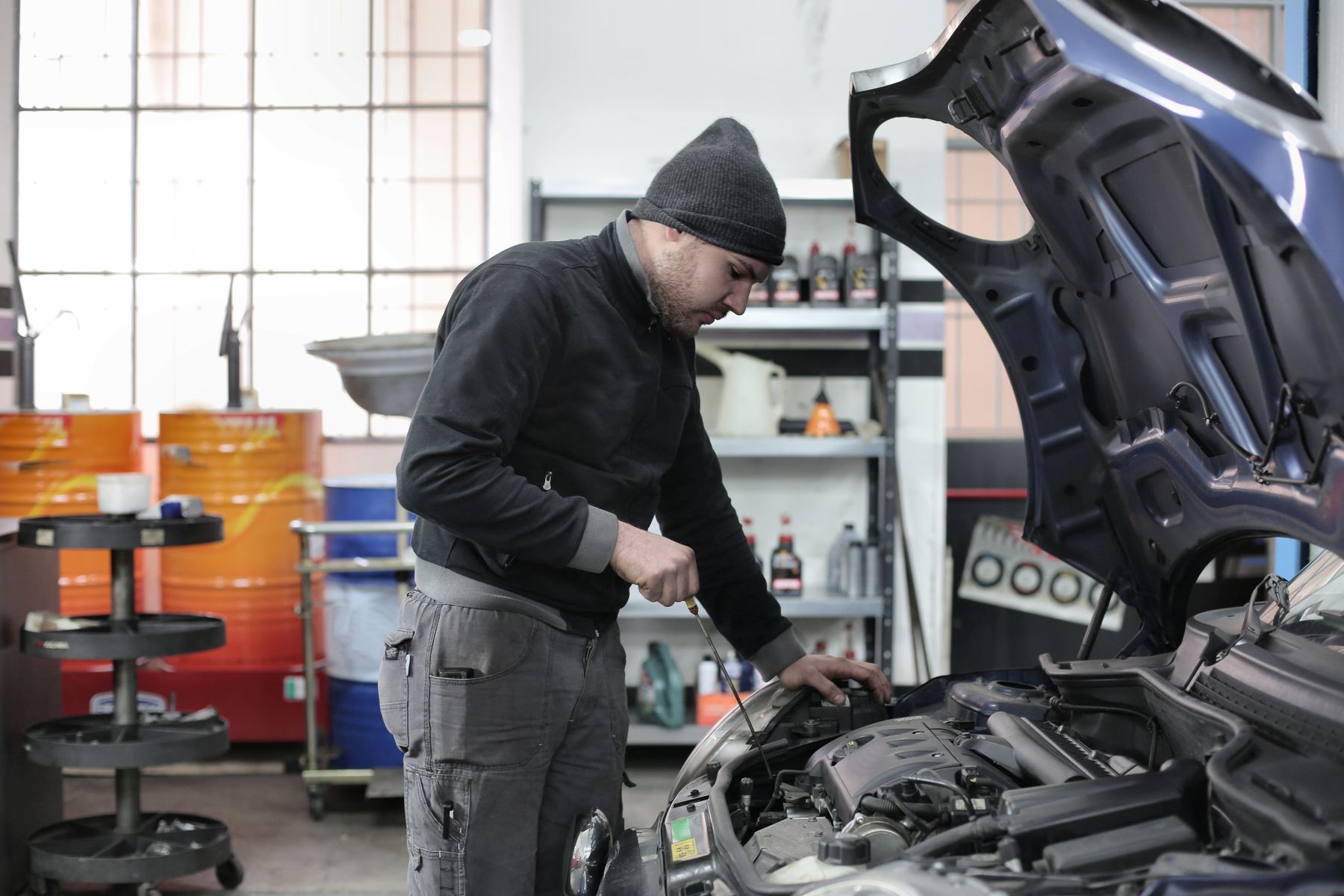 Mechanic checking engine oil during a car service at an independent Waterford workshop